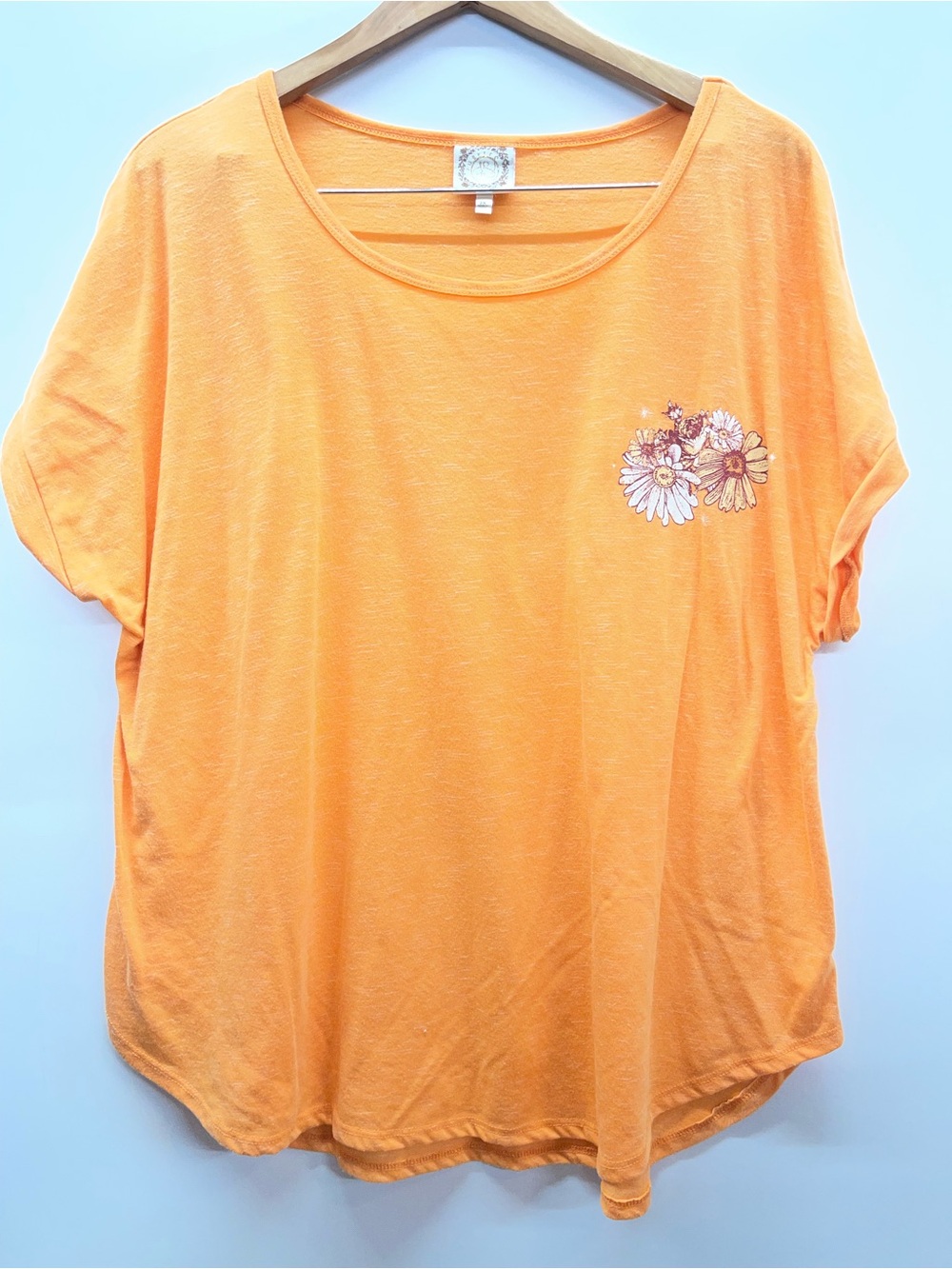 True Self orange‎ short sleeve top featuring a sun and moon graphic design.